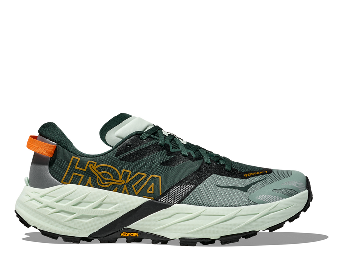 Trail running shoe with green upper, light green midsole, and aggressive black outsole tread
