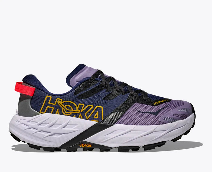 Trail running shoe with purple mesh upper, navy accents, and white chunky midsole, side view