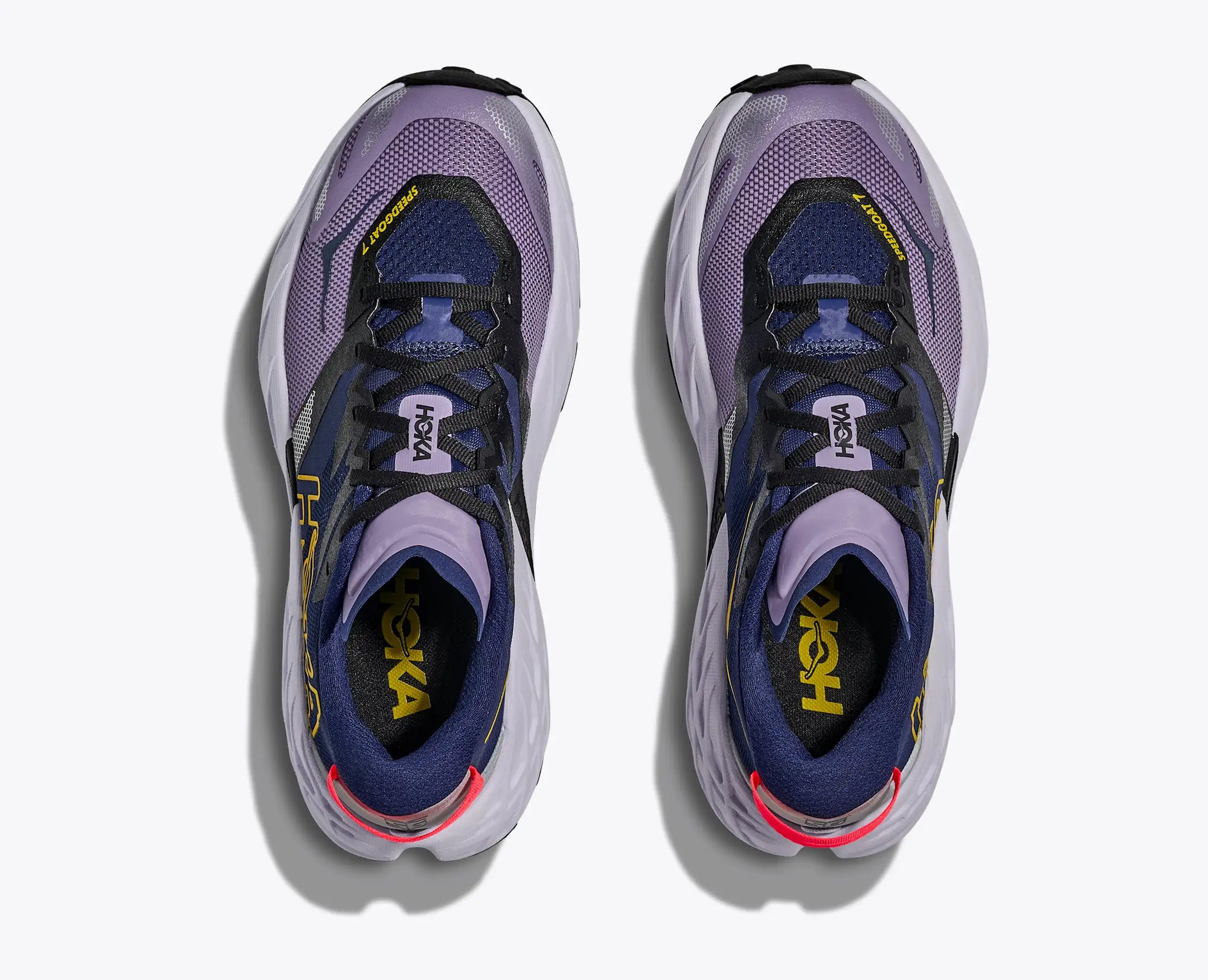 Purple and navy trail running shoes with mesh upper, top-down view showing lace system