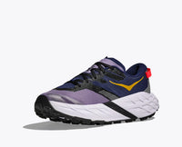 Purple and navy trail running shoe with white midsole and black outsole, side view