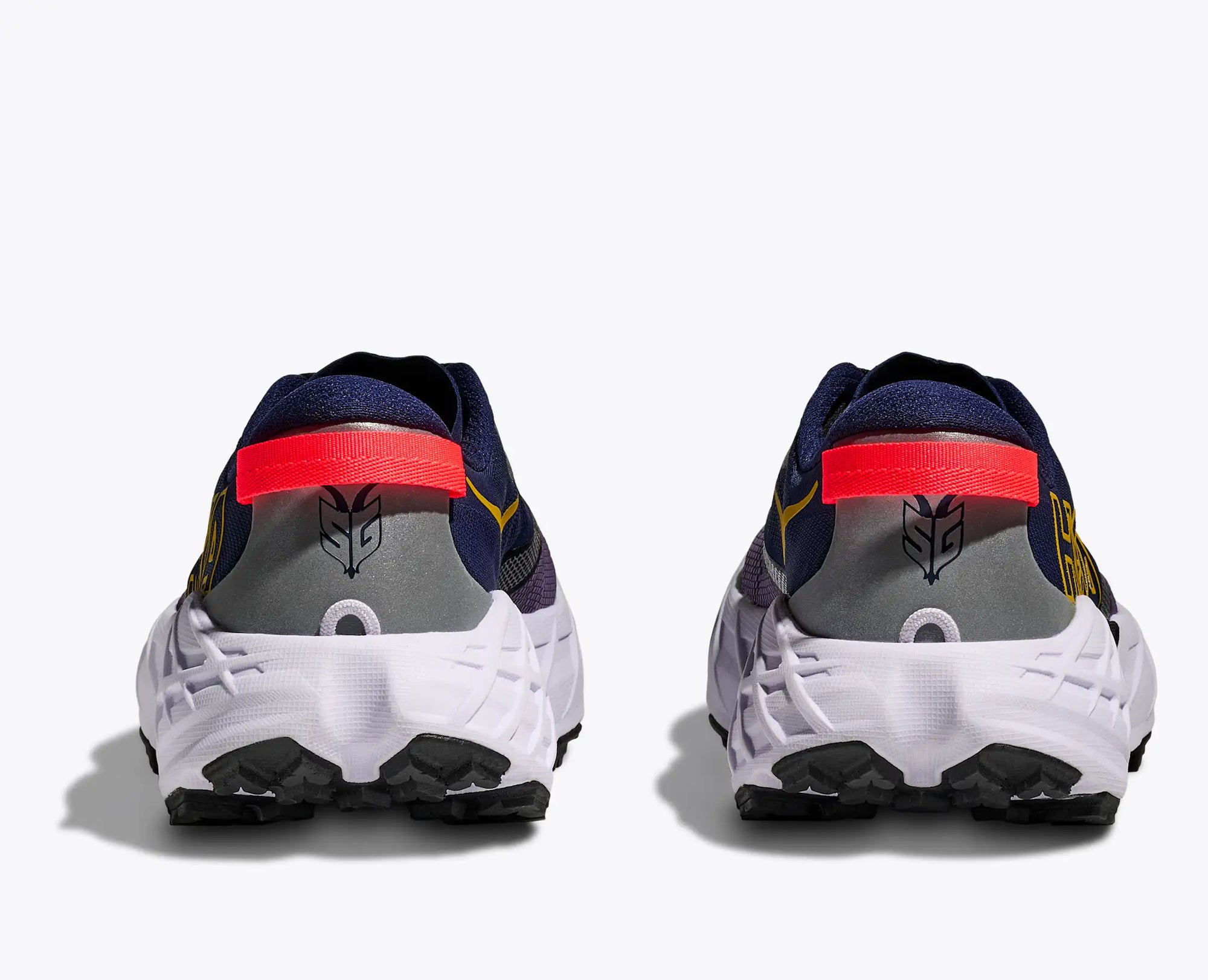Trail running shoes shown from rear view with white chunky sole and black traction lugs