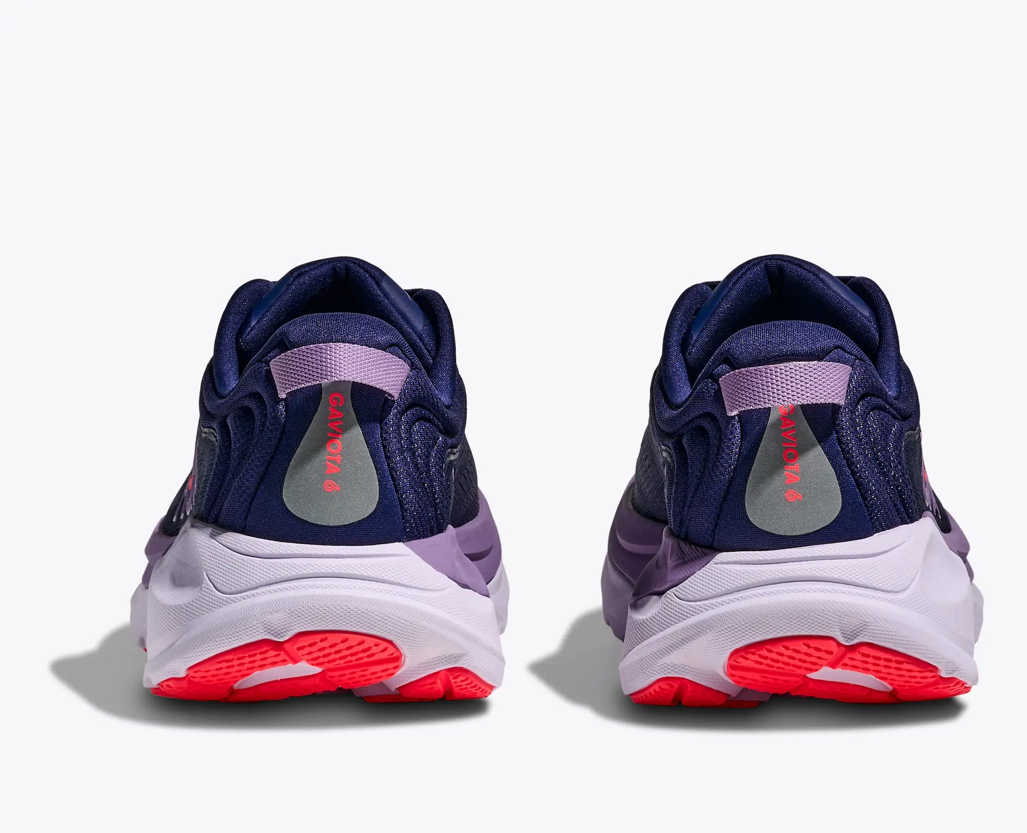 Running shoes rear view showing navy upper with purple midsole and red sole details