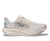 Light colored running shoe with mesh upper and thick curved sole, side profile view