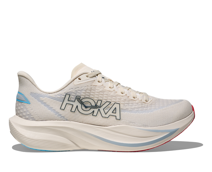 Light colored running shoe with mesh upper and thick curved sole, side profile view