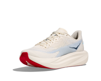 Light colored running shoe with textured upper, thick midsole, and red outsole detail