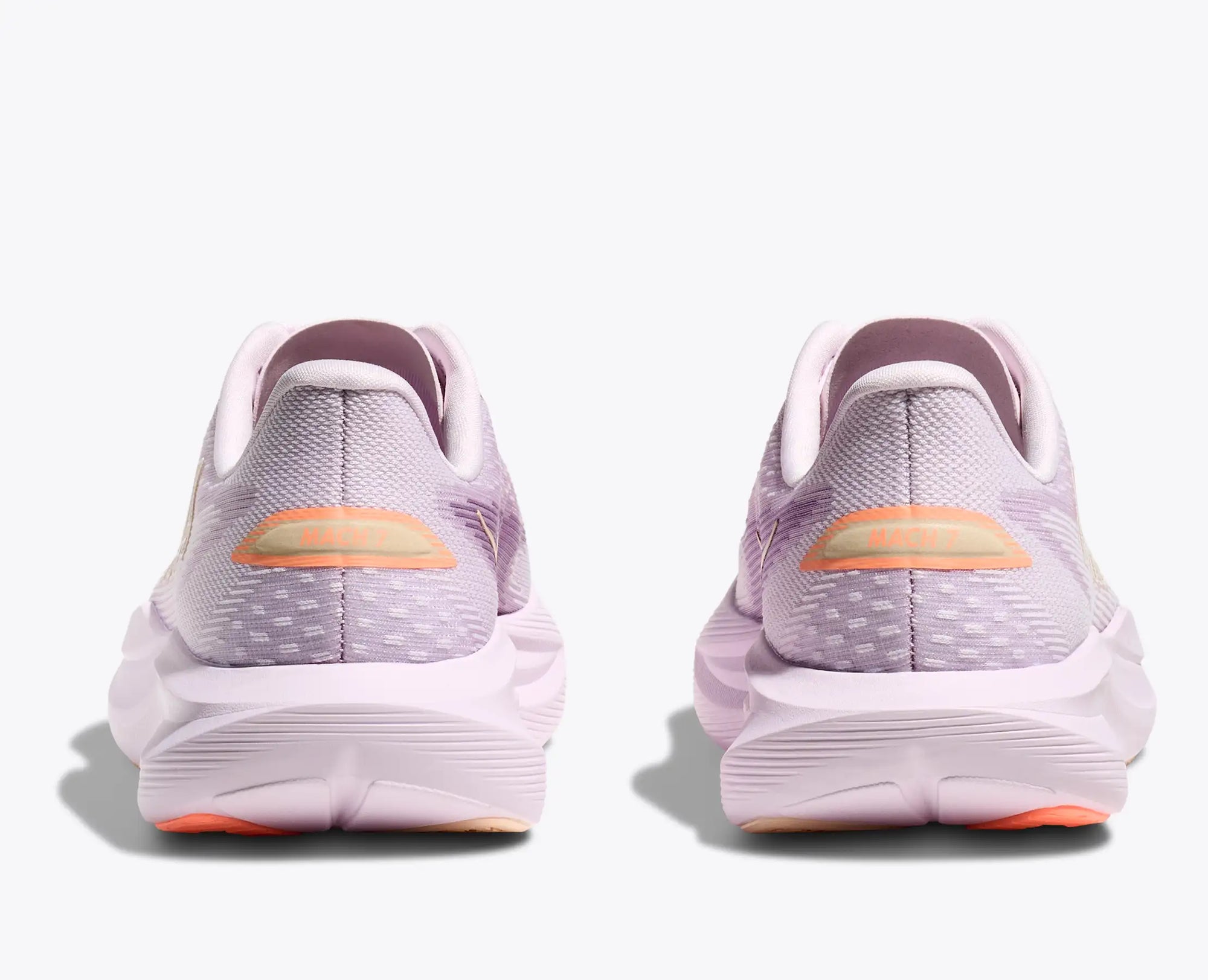 Light purple running shoes shown from back heel view with orange accent detail