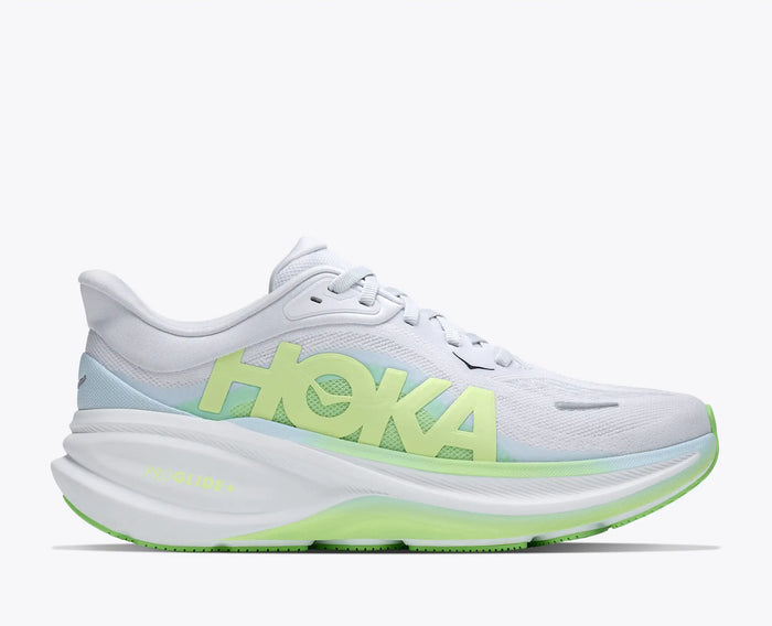 Women's running shoe with thick cushioned midsole, lime green accents, and bold side branding, lateral view