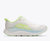 Women's running shoe with thick cushioned sole, white upper, and neon green accents, lateral view