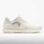 Women's tennis shoe in white with grey mesh panels and silver logo, lateral view
