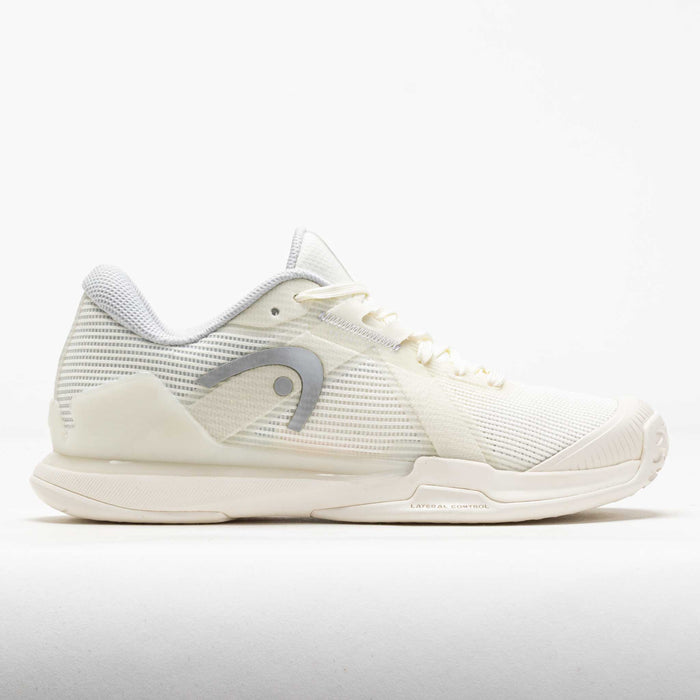 Women's tennis shoe in white with grey mesh panels and silver logo, lateral view