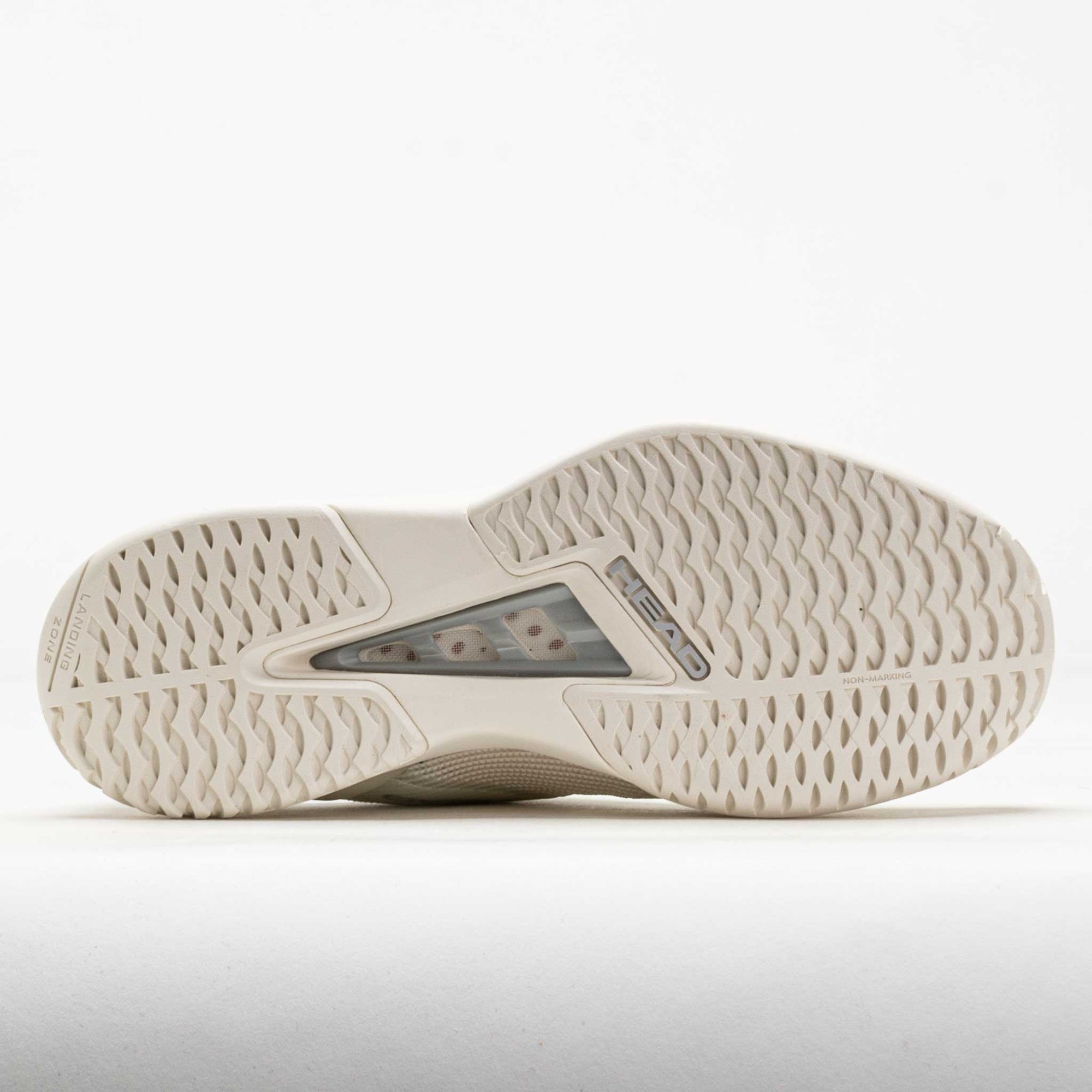 Bottom sole view of a tennis shoe showing herringbone tread pattern and heel cushioning unit