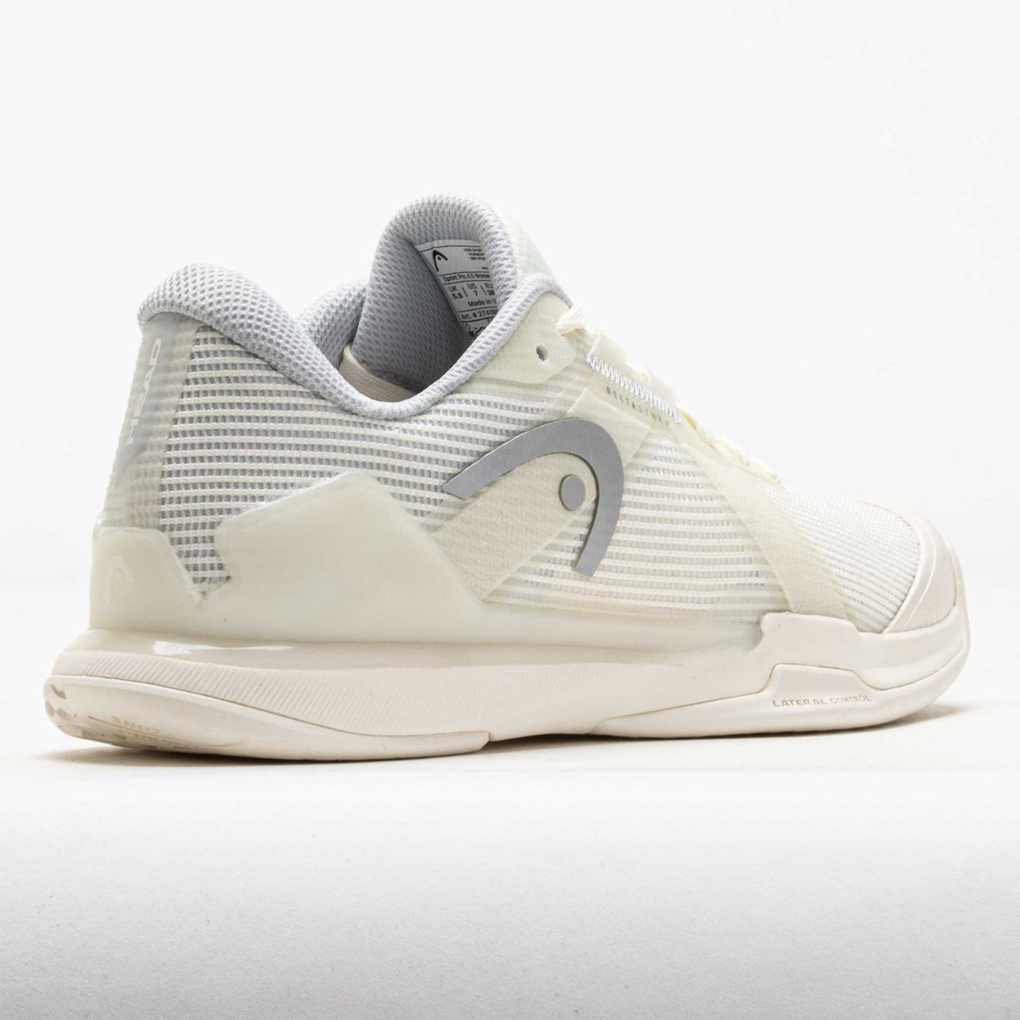 Women's tennis shoe rear three-quarter view, white with grey mesh panels and brand logo