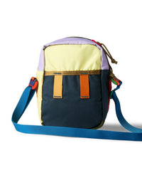 Small crossbody shoulder bag with colorblock panels, blue strap, and orange accent loops, front view