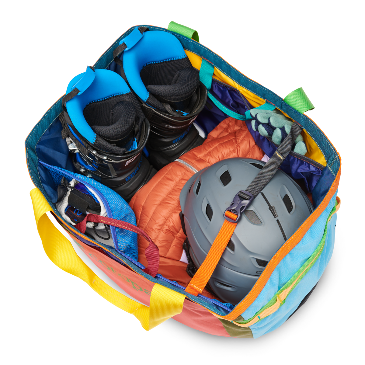 Large multicolored duffel bag packed with outdoor gear including helmet, boots, and climbing equipment