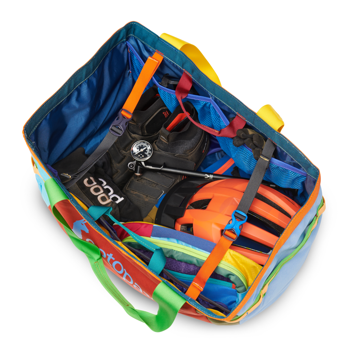 Open multicolored duffel bag showing packed gear including life vest, compass, and other outdoor equipment