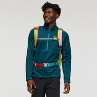 Travel backpack with multicolored rainbow straps and chest belt worn by model on white background