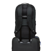 Black backpack shown from back view with padded straps and luggage pass-through feature