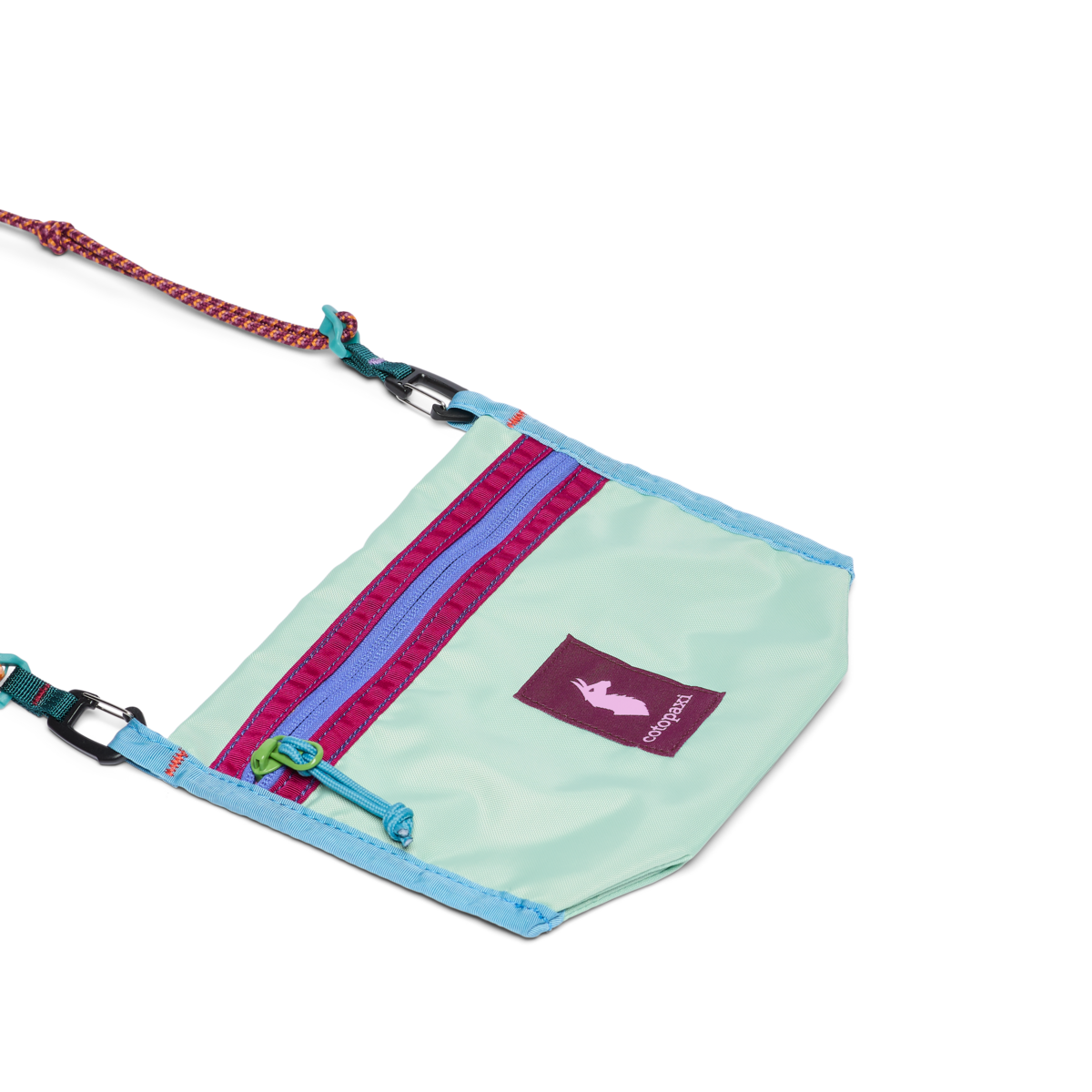 Small mint green crossbody bag with colorful zipper pocket, rope strap, and carabiner clips