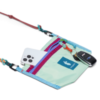 Small crossbody pouch with rope strap, showing phone pocket and key fob clip, open view