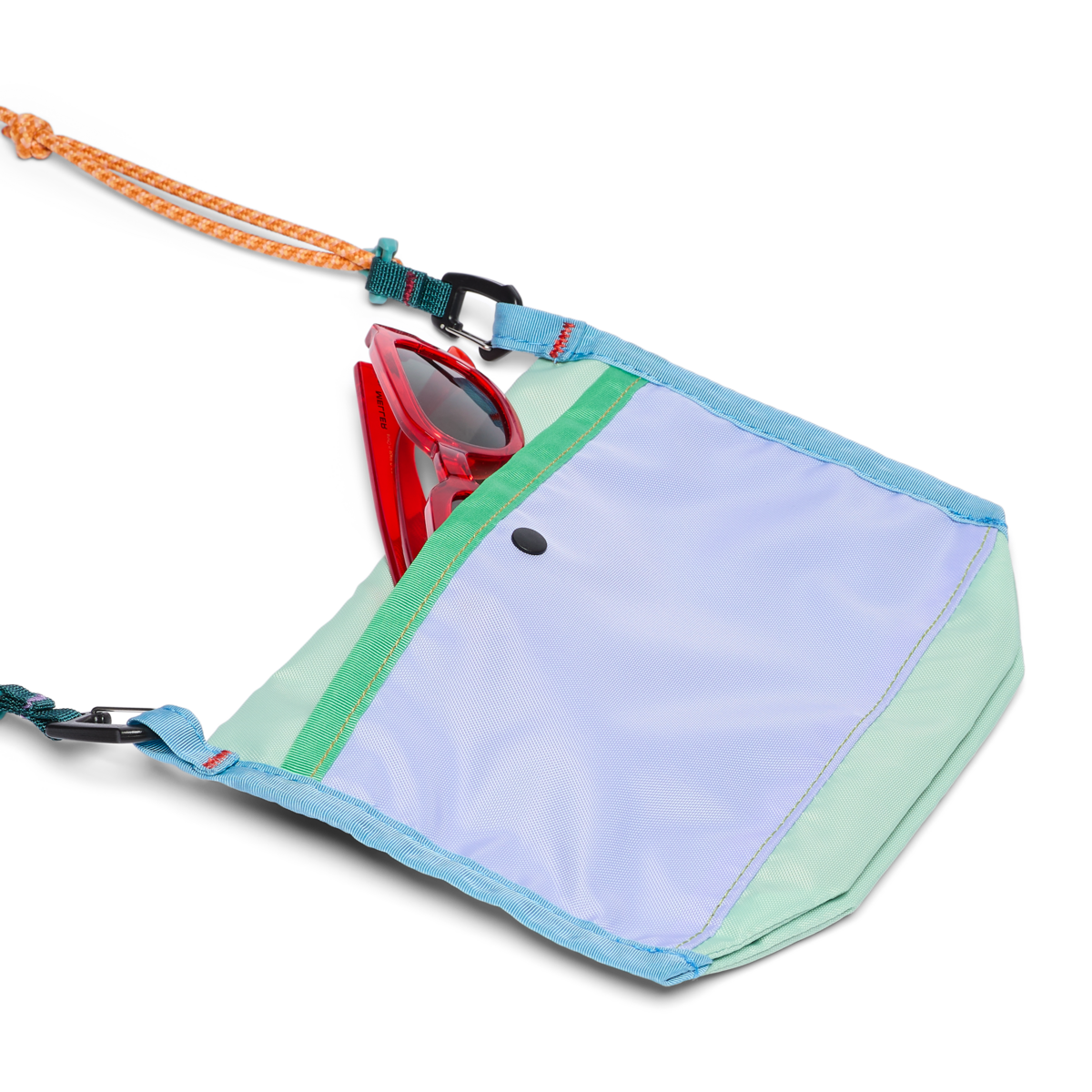 Small crossbody bag open showing red sunglasses inside, with orange rope strap and carabiners