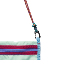 Close-up of crossbody sachet bag with mint fabric, striped zipper detail, and carabiner clip connector