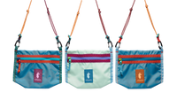 Three small crossbody bags with colorful zipper pockets and braided rope straps, front view
