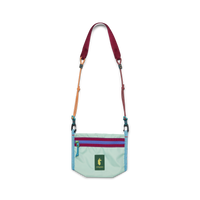 Small mint green crossbody bag with colorful rope strap, dual zippers, and llama logo patch