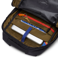 Interior view of a 26L backpack showing organized compartments with laptop sleeve, keys, notebook, and accessories