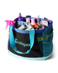 Large tote bag with colorful panels filled with travel and grooming items