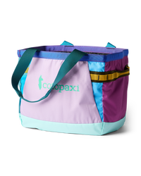 Colorful patchwork tote bag with multiple fabric panels and teal handles on white background