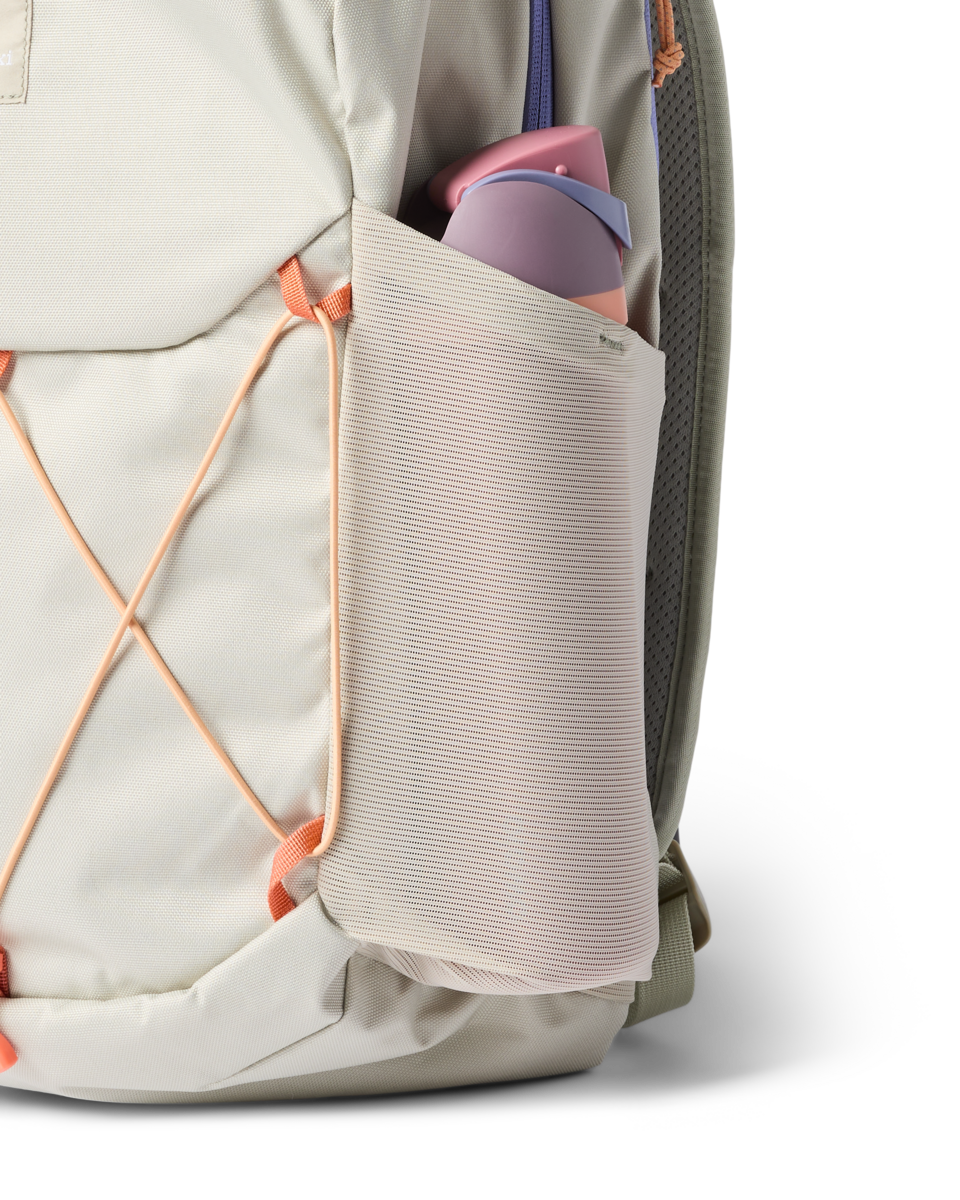 Light gray daypack with orange bungee cord system and side water bottle pocket, detail view