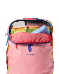 Multicolored travel backpack with main compartment open showing interior organization pockets and mesh compartments