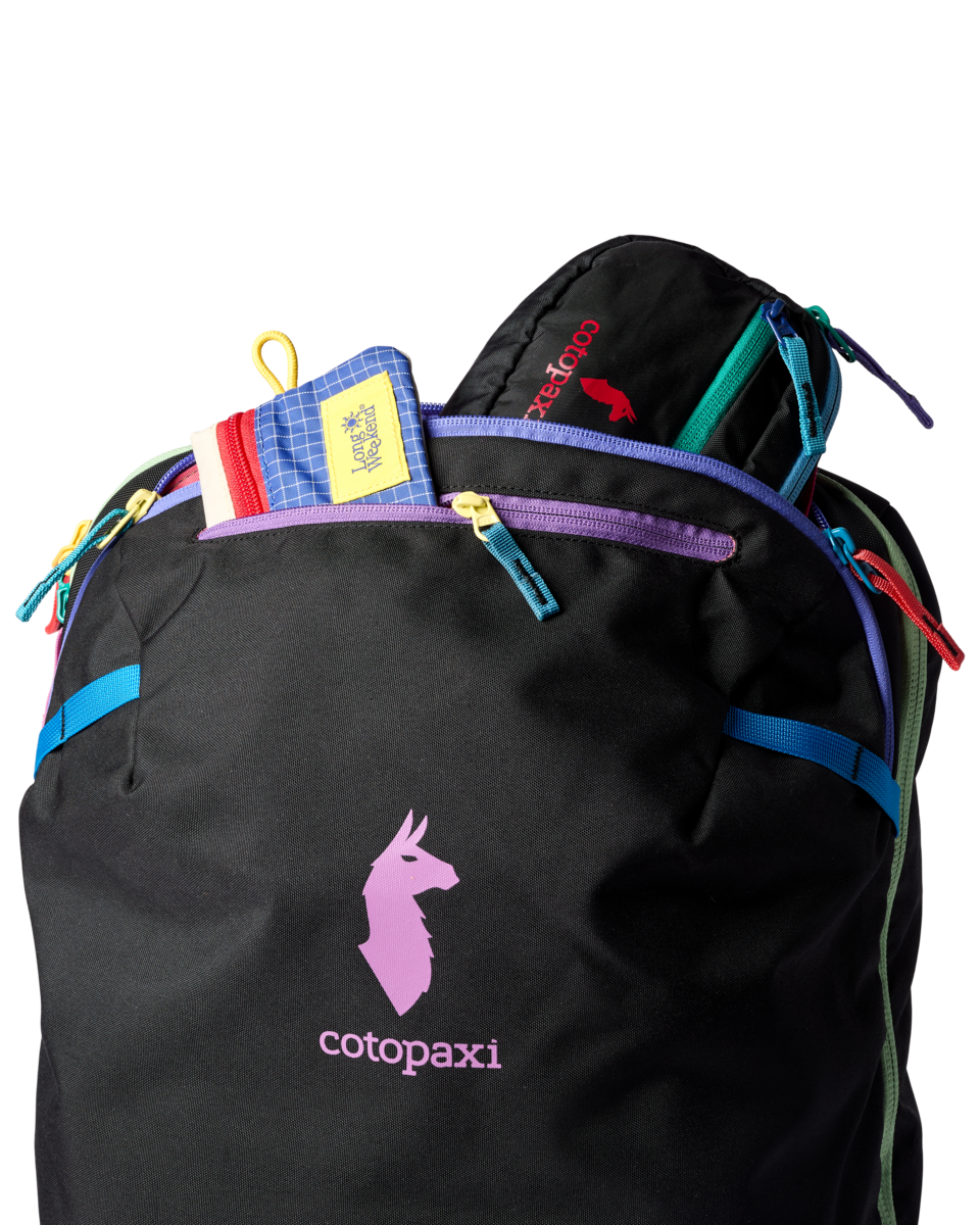 Black travel backpack with colorful zipper accents and top loading compartment open showing contents