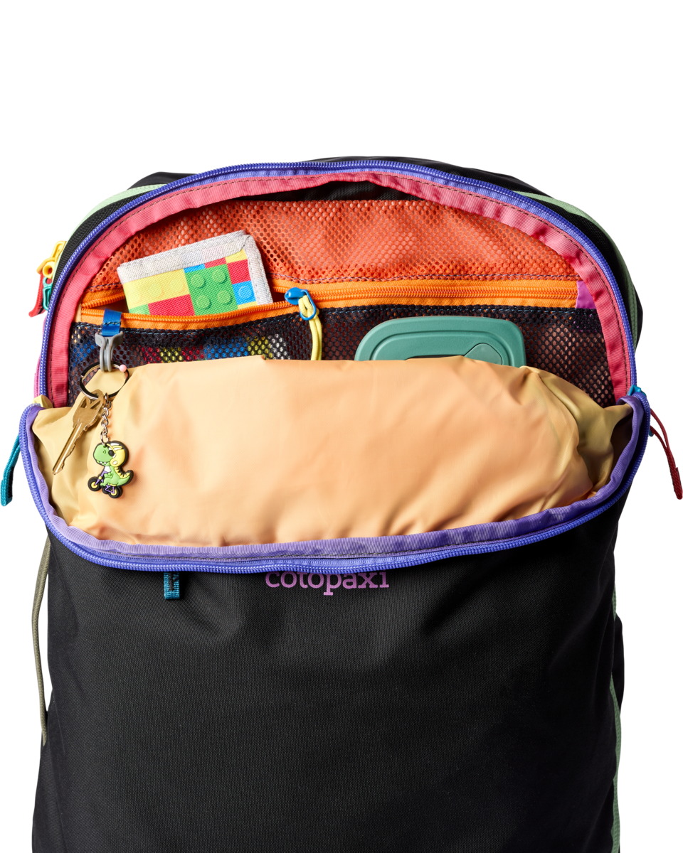 Black travel backpack open showing colorful rainbow interior compartments and organization pockets