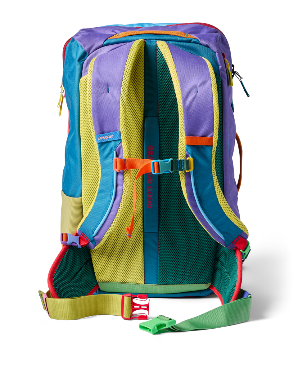 Multicolored travel backpack showing back panel with padded straps and chest strap