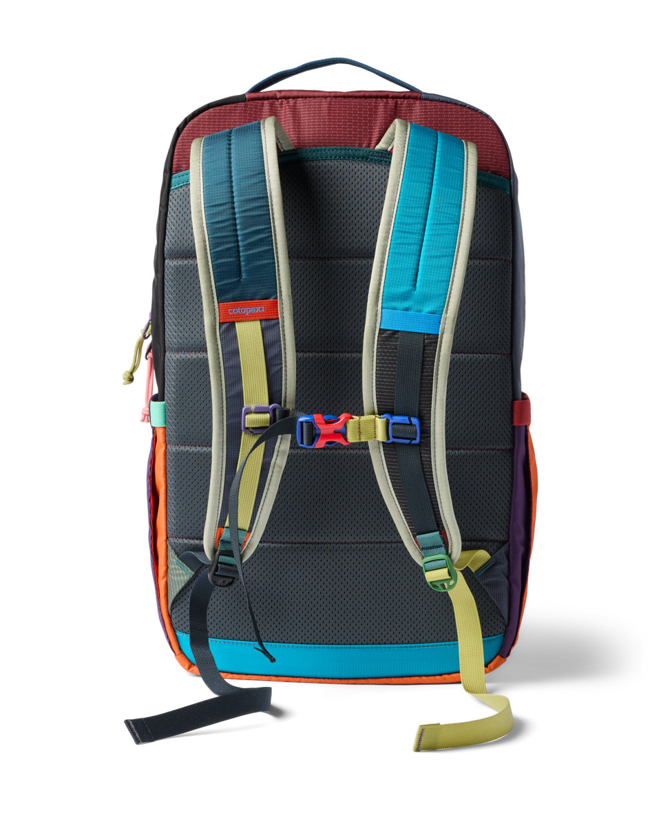 Multicolor patchwork backpack rear view showing padded straps, sternum strap, and mesh back panel
