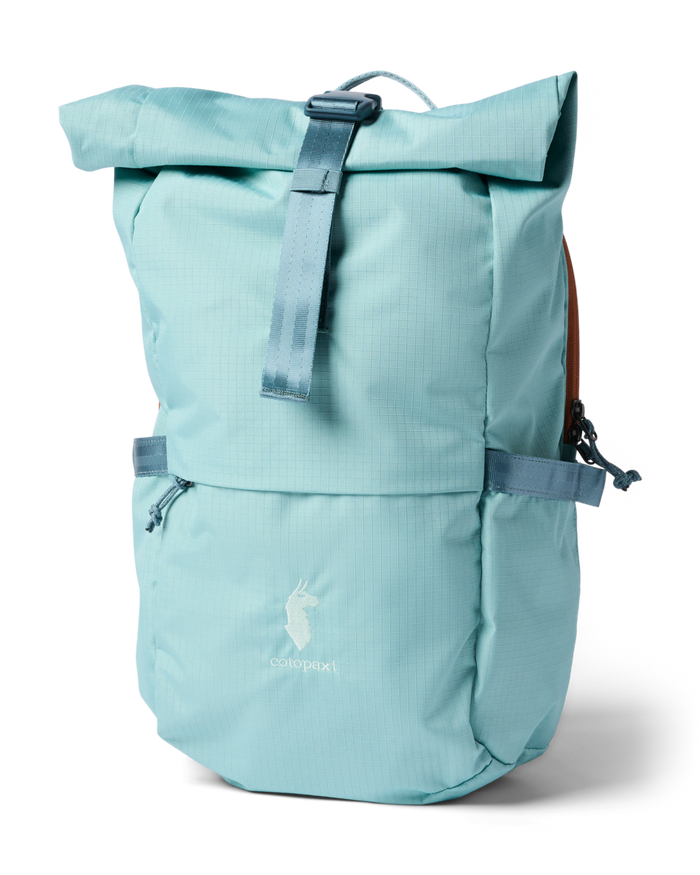 Roll-top daypack in light aqua with front zip pocket, buckle strap, and tan side panels