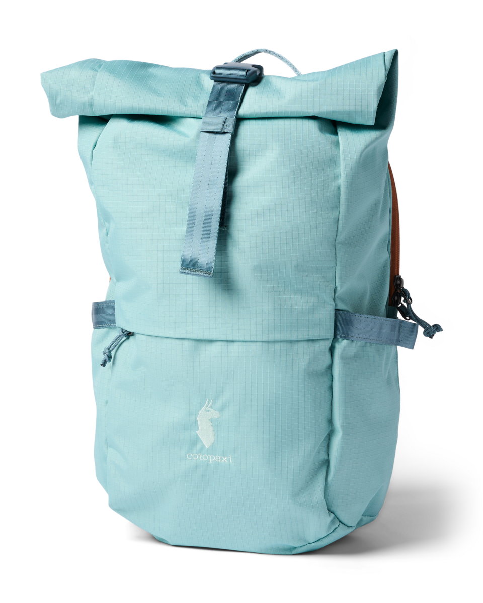 Roll-top daypack in light aqua with front zip pocket, buckle strap, and tan side panels