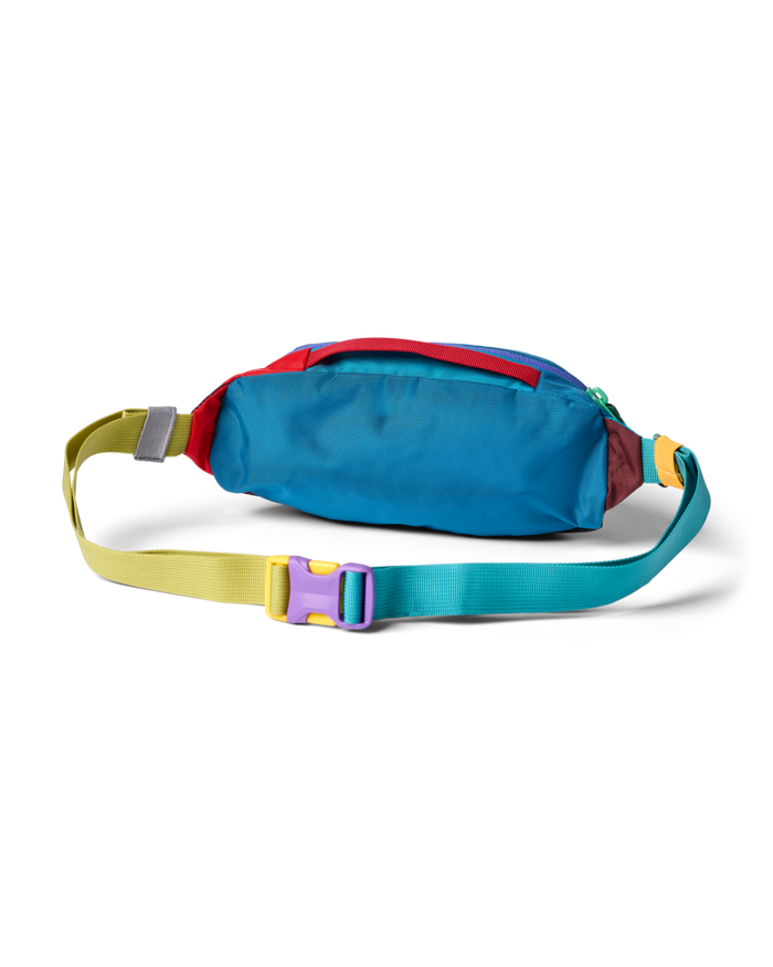 Colorful hip pack with blue body and rainbow webbing strap against white background