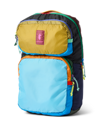 Colorful patchwork backpack with multiple compartments and rainbow zipper pulls, three-quarter view