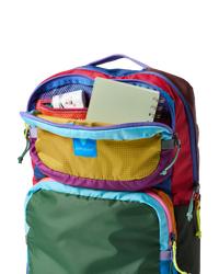 Multicolored patchwork backpack with multiple compartments open showing interior organization and storage