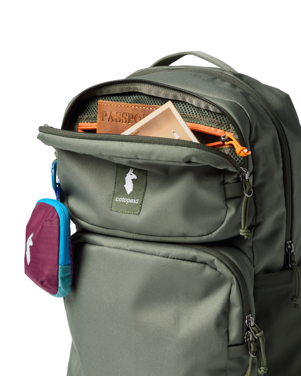 Olive green backpack with open front compartment showing passport and organizational pockets