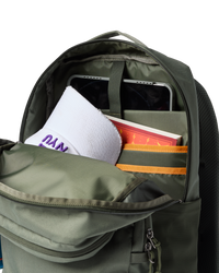 Olive green backpack with main compartment open showing laptop sleeve and organizational pockets