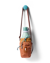 Water bottle sling bag with drawstring top holding a mint green bottle, hung on a wall hook