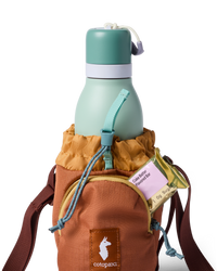 Water bottle sling bag holding a mint green insulated bottle with snack bar in side pocket
