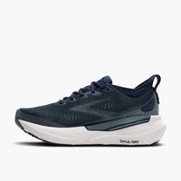 Navy blue and teal athletic running shoe with mesh upper, side profile view
