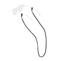 Brown suede eyewear retainer strap with adjustable ends attached to clear safety glasses