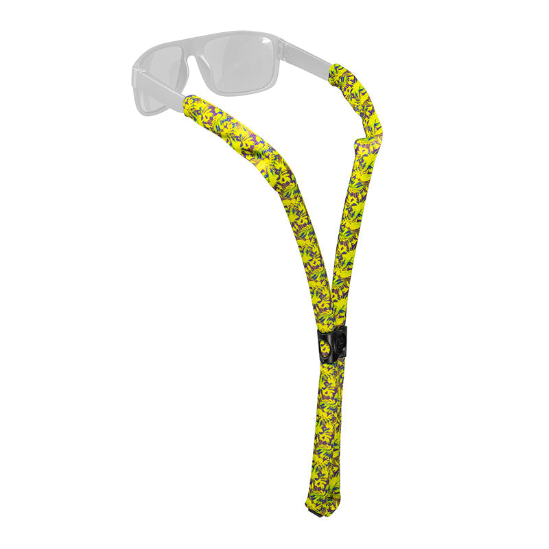 Yellow patterned floating eyewear retainer strap attached to clear sunglasses on white background
