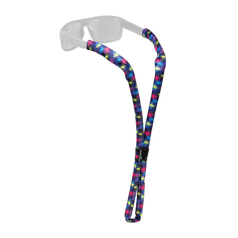 Colorful patterned eyewear retainer strap attached to clear safety glasses on white background