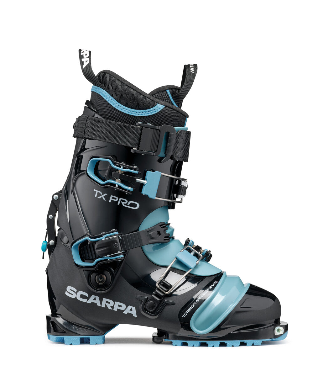 Alpine touring ski boot with three buckles, black shell and light blue toe box, side view